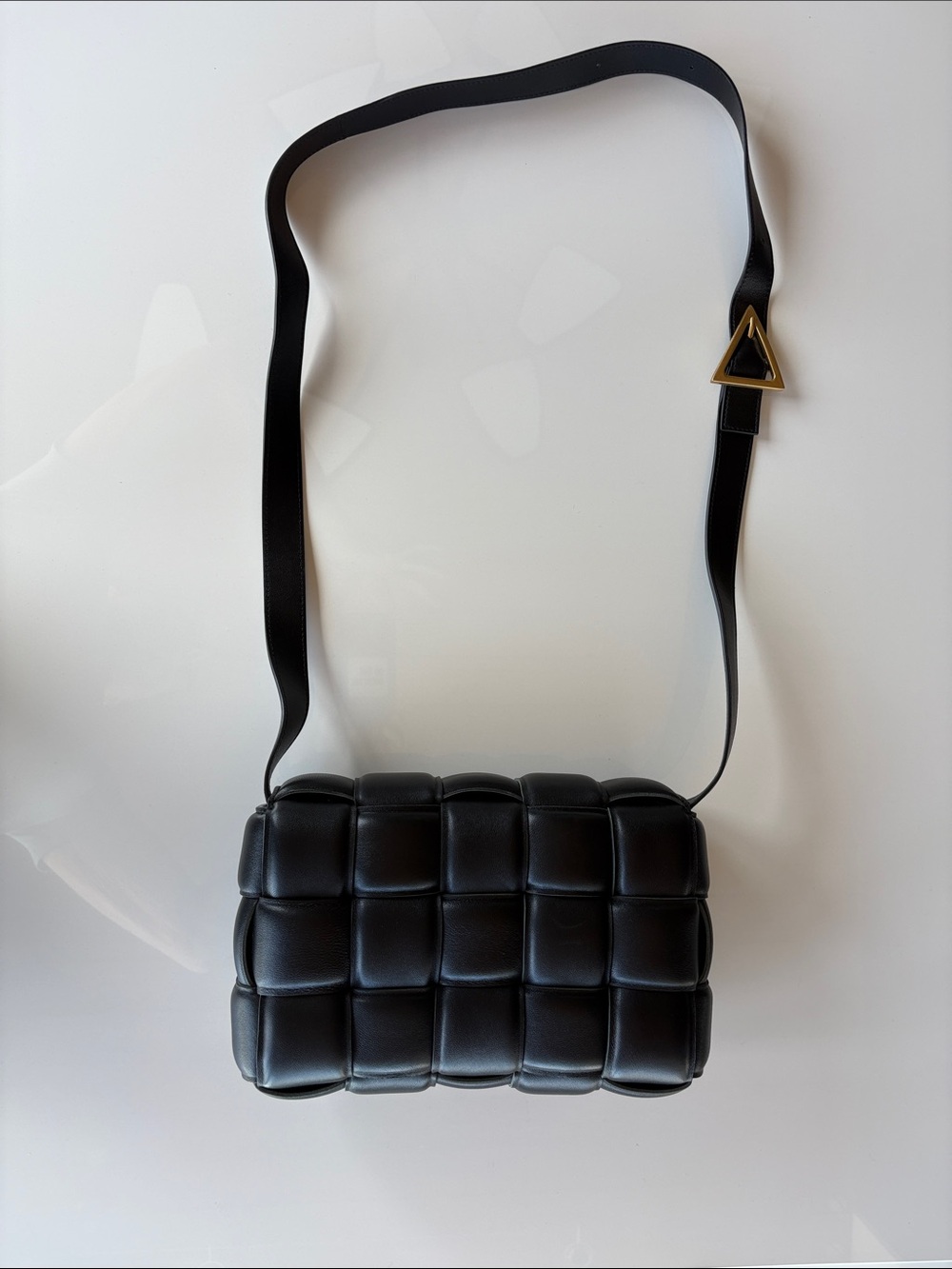 Bottega Veneta Black Padded Cassette Crossbody with Gold Triangle Accent